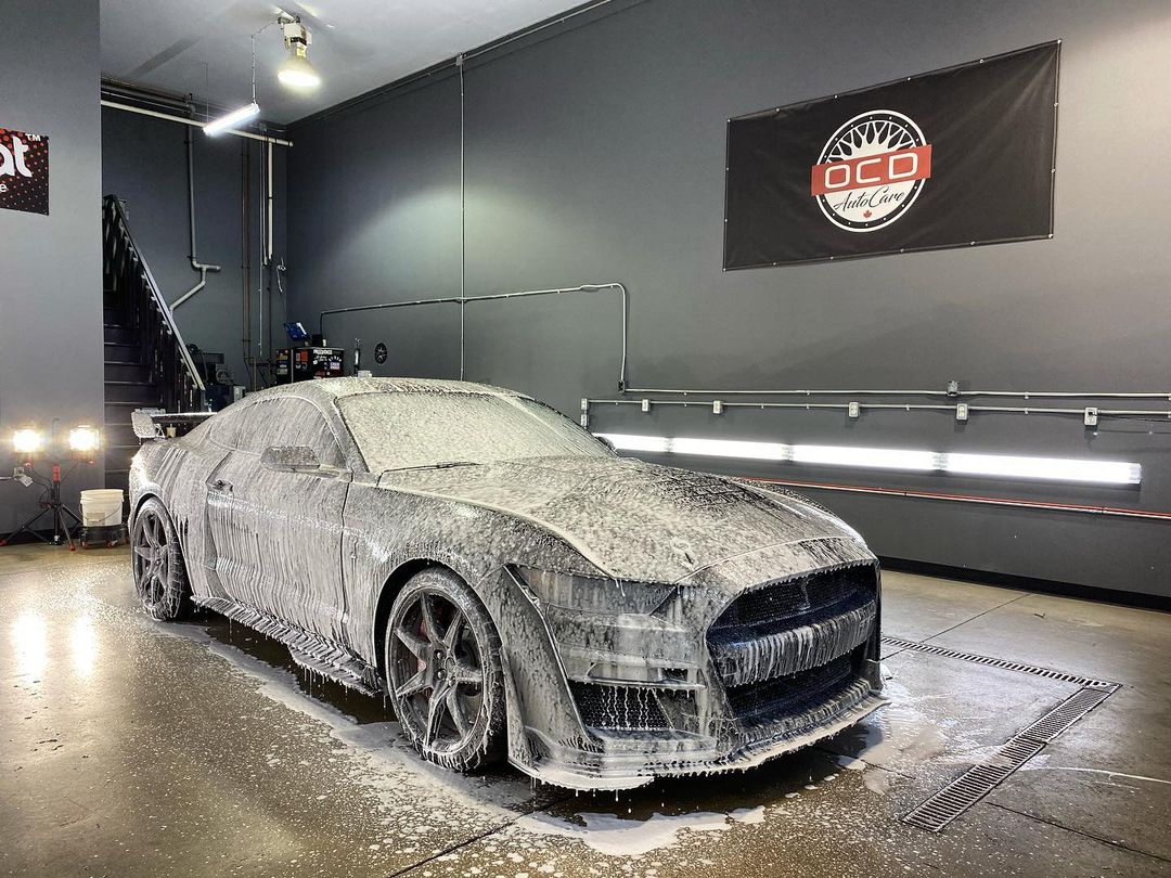 OCD Auto Care detailing a car in the shop